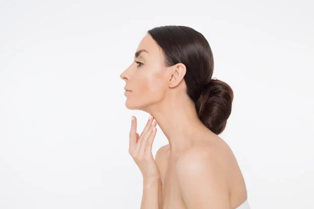 Woman with a defined jawline and smooth neck highlighting facial contouring, skin tightening, and youthful appearance.
